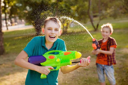 Ramakra | smiling boys playing with water toy guns